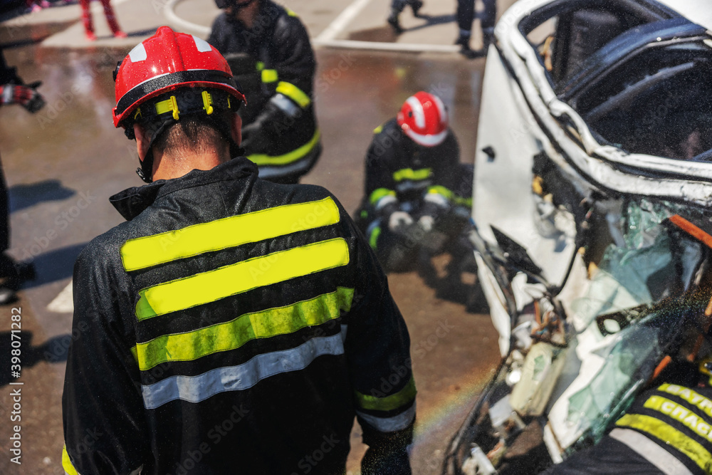Firemen trying to release man from crashed car. There is a crashed cars in car accident. Firemen trying to release man from crashed car. There is a crashed cars in car accident.