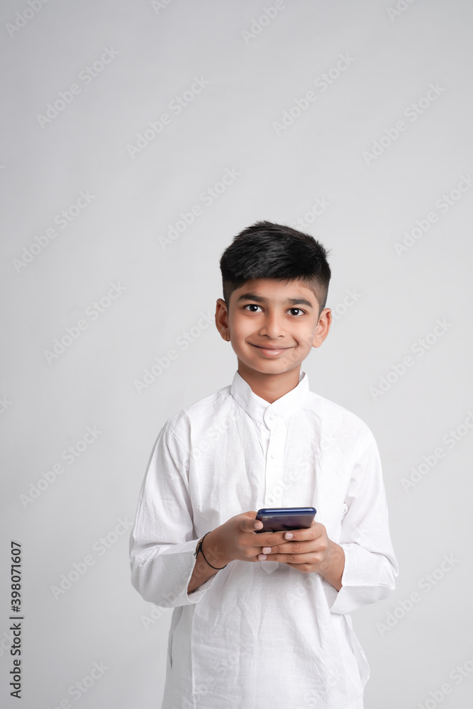 Cute Indian little boy using smart phone Cute Indian little boy using smart phone