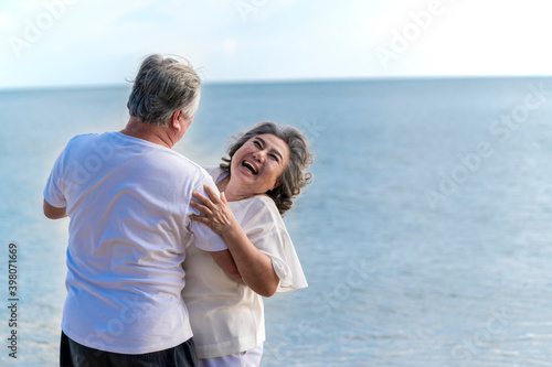 Happy asian senior retired couple, relax smiling elder man and woman enjoying with retired vacation at sea beach outdoor. Health care, Family outdoor lifestyle © lukyeee_nuttawut