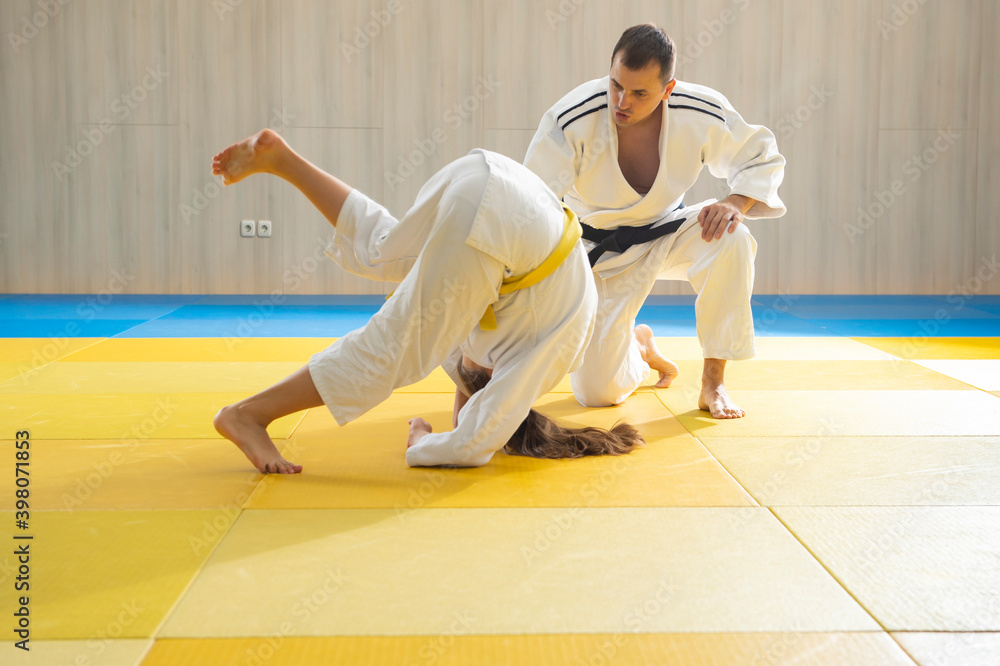 Judo master and young judo girl are training Judo master and young judo girl are training