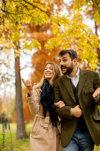 Young couple walking in the autumn park