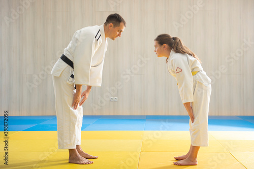 Judo master and young yellow belt judo girl