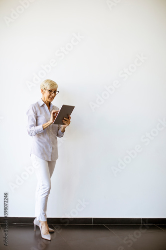 Mature businesswoman using ...