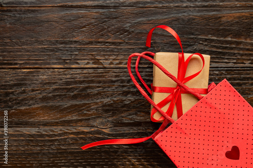 Paper craft Gift box with red ribbon bow, paper bag and red hearts. Festive concept for Valentine's day, Mother's day or birthday.