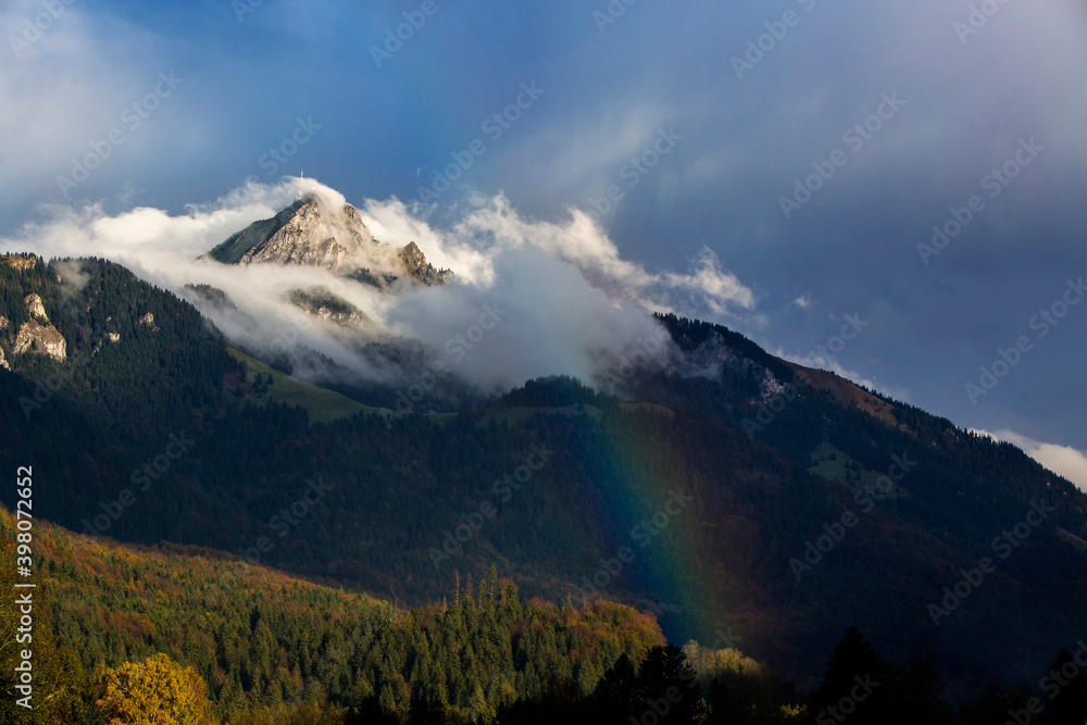 Bavarian mountain Wendelstein with fog and rainbow