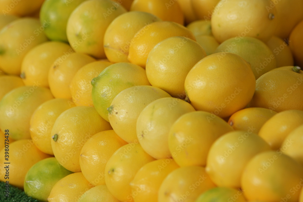 Display of lemons at fruits market. Ripe organic lemons texture. Rich with vitamins. Display of lemons at fruits market. Ripe organic lemons texture. Rich with vitamins.