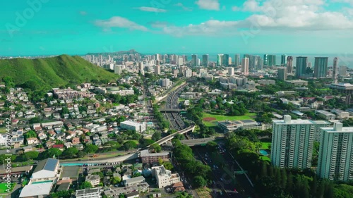 Aerial view of the Punchbowl crater and the National Memorial Cemetery of the Pacific.  Diamond Head Crater with Honolulu skyline in the background. Oahu island. Hawaii. Unites States.