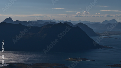 Beautiful aerial panorama view over the rugged mountains and fjords of Lofoten, a chain of islands in northern Norway, on sunny summer day with few clouds viewed from Matmora peak.