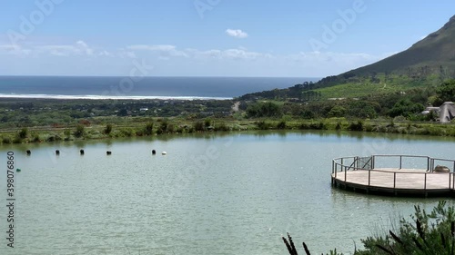 Noordhoek beach Chapmans Peak drive along the Atlantic Seaboard side of the Cape Peninsula taken from Cape Point Vineyard pond photo