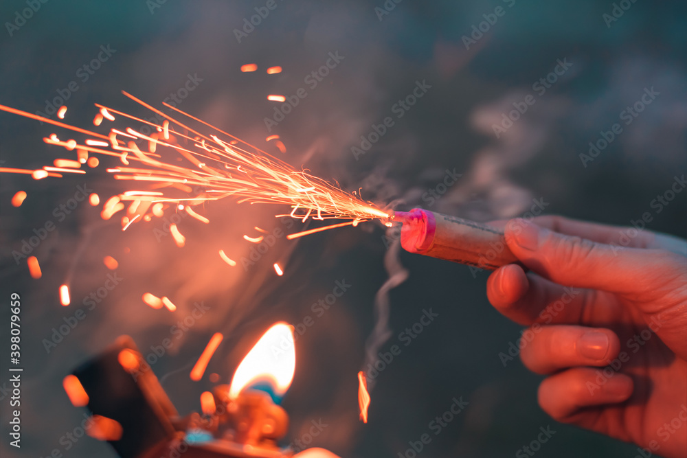 Young Man Lighting Up Firecracker in his Hand Using Gasoline Lighter. Guy  Getting Ready for New Year Fun with Fireworks or Pyrotechnic Products -  CloseUp Shot, Rear View Stock Photo | Adobe Stock