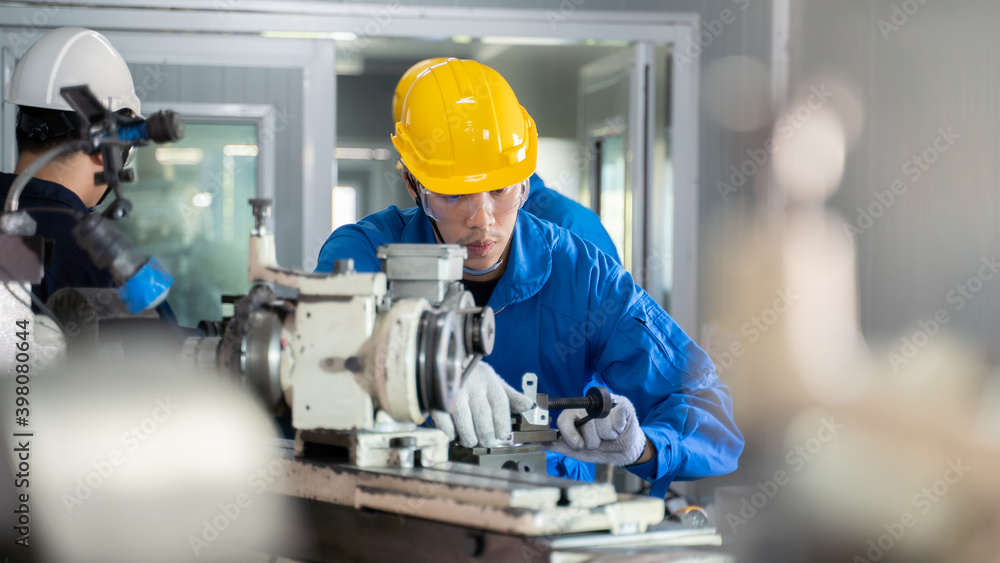 Mechanic operate lathe grinding machine with safety protective device. Mechanic operate lathe grinding machine with safety protective device.