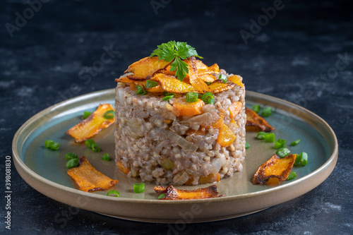 Boiled buckwheat with fried carrots and onions  close up