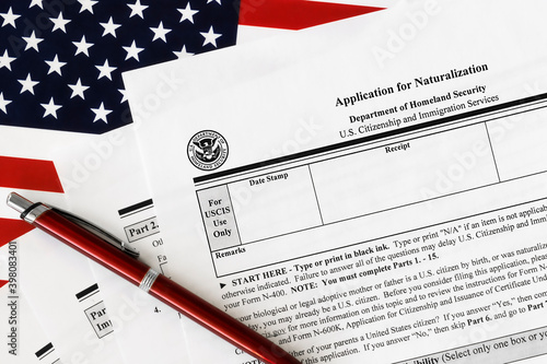 close-up of n-400 form. application for naturalization topview, on a background of United States flag.