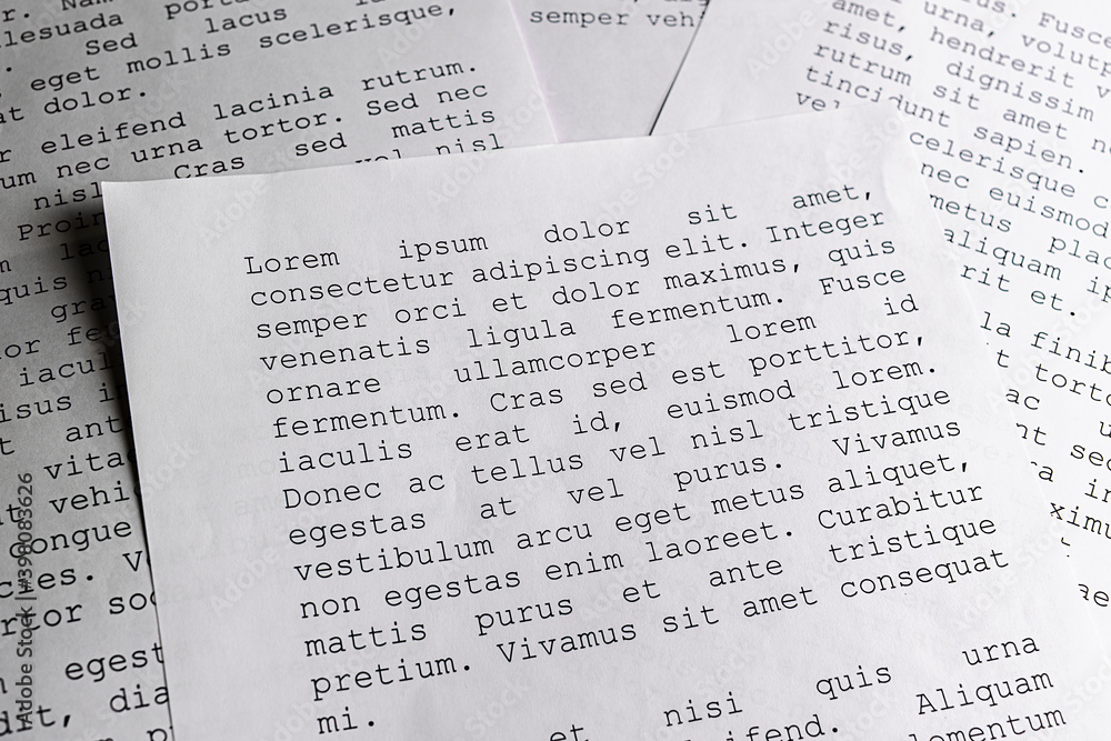 Fototapeta premium lorem ipsum dolor sit amet concept. selective focus photo of paper sheets with publishing and graphic design placeholder text on them.