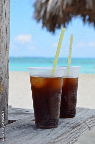 Canvas Print Cuba Libre cocktail with straws on a wooden table on Varadero beach in Cuba, tur