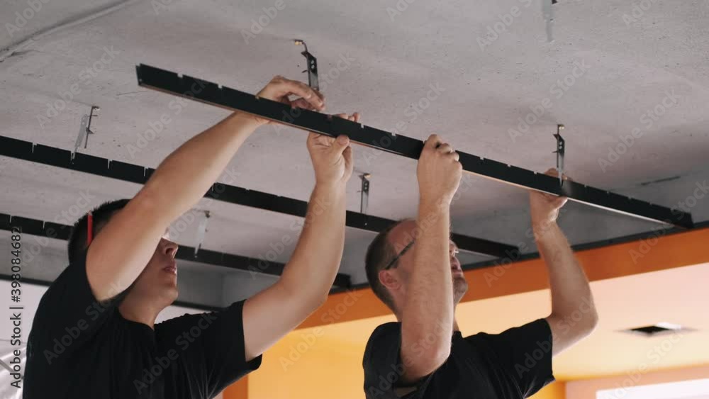 Video Stock European moder ceiling concstructions. Worker installing ...