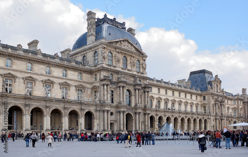  Place Carrousel, Louvre. Tourists walk and take pictures photo