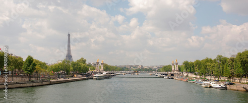  View of the Alexander lll Bridge . By the embankments are moving cars and pedestrians