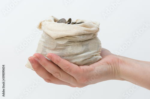 Fotografija on the human palm lies an open bag of coins