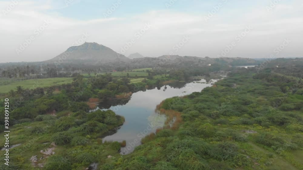 An almost dried out Then Pennai River in India surrounded by lush green landscape An almost dried out Then Pennai River in India surrounded by lush green landscape