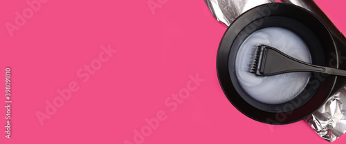 hair dye with brush in mixing bowl on pink background. Horizontal banner