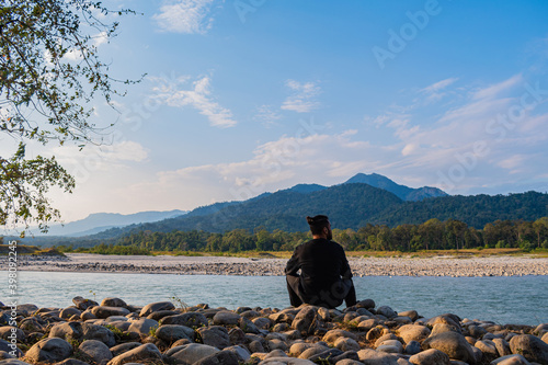 Manas National Park - a Person sitting by the banks of river Manas (ID: 398092245)