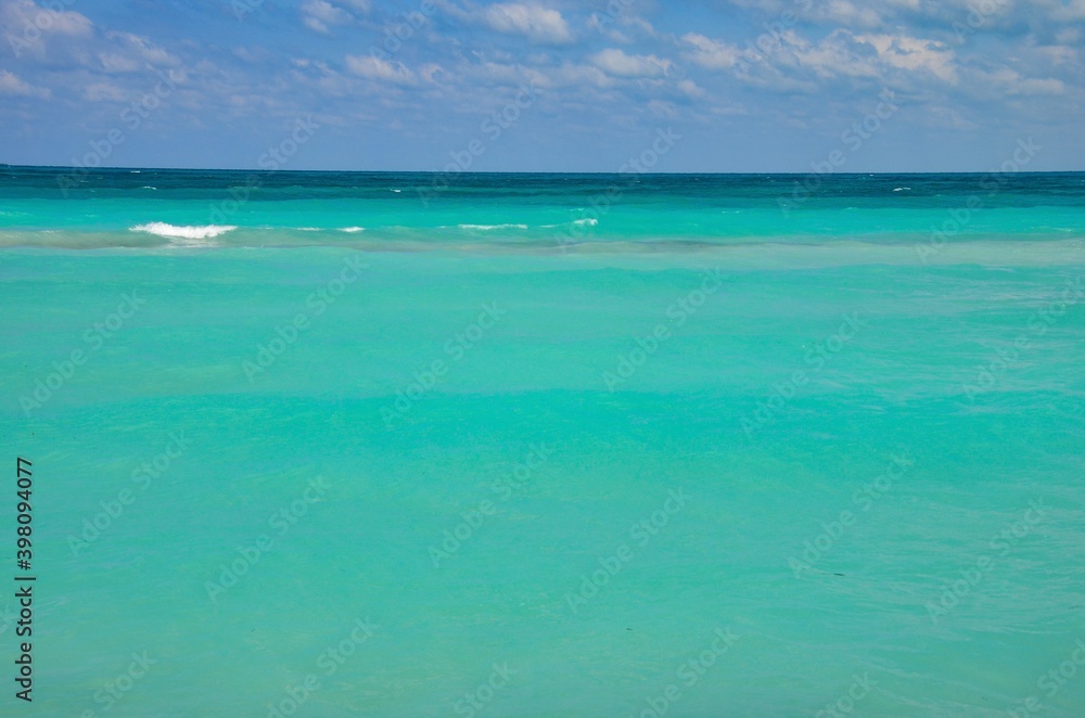Turquoise caribbean sea on Varadero coast in Cuba, blue sky with clouds background, copy space