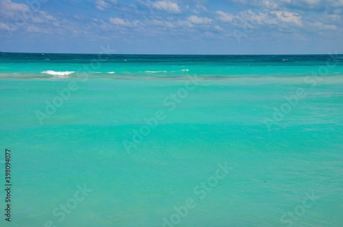 Turquoise caribbean sea on Varadero coast in Cuba, blue sky with clouds background, copy space