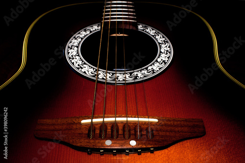 Close up of acoustic guitar on black background photo