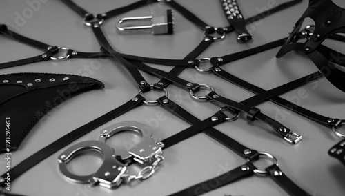 Set of erotic toys for BDSM. The game of sexual slavery with a whip, gag and leather blindfold. Intimate sex games