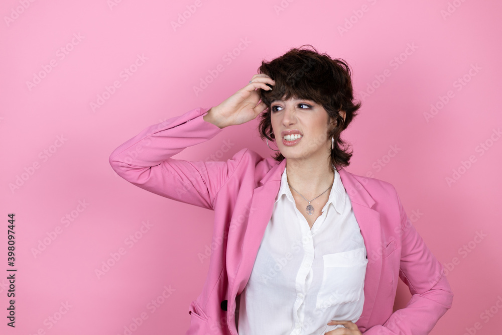 Young business woman over isolated pink background confuse and wonder about question. Uncertain with doubt, thinking with hand on head Young business woman over isolated pink background confuse and wonder about question. Uncertain with doubt, thinking with hand on head