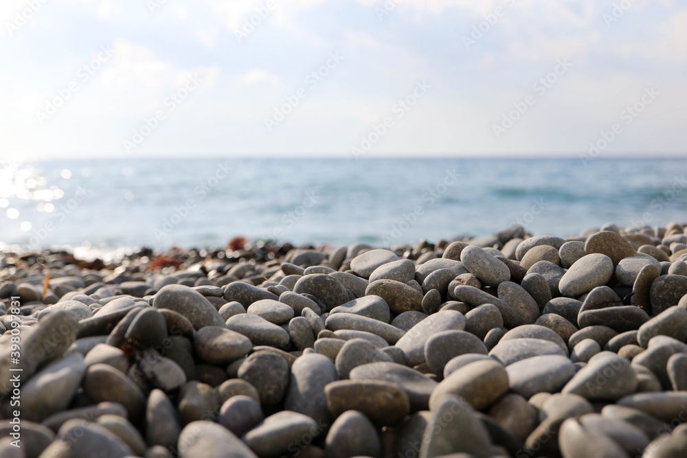 smooth pebbles stones on the beach with the sea on the background smooth pebbles stones on the beach with the sea on the background