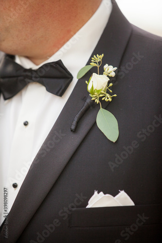 black tuxedo and bow tie with boutonniere photo