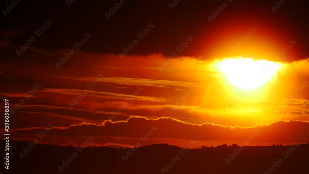 Skyscape. Burning sky, dark stormy clouds. Red orange color sunset over sea. Nature, coastal landscape. Capi Corb, Mediterranean coast of Spain. Skyscape. Burning sky, dark stormy clouds. Red orange color sunset over sea. Nature, coastal landscape. Capi Corb, Mediterranean coast of Spain.