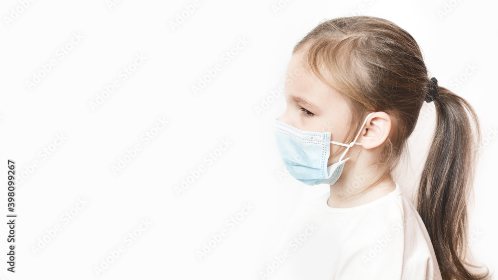 Little Caucasian preschool girl in a medical protection mask pm2.5. side view Baby on white background with copy space. epidemic, pandemic. Coronavirus quarantine. protect loved ones Little Caucasian preschool girl in a medical protection mask pm2.5. side view Baby on white background with copy space. epidemic, pandemic. Coronavirus quarantine. protect loved ones