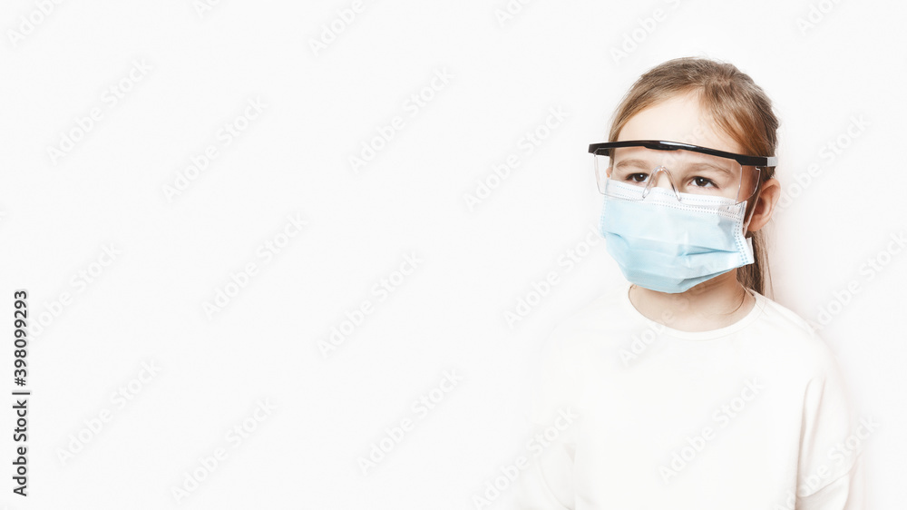 Coronavirus protection. The face of a child in a mask and glasses. A little preschool girl observes the prevention of covid 19. Children's health and viruses. Respiratory protection for babies. Coronavirus protection. The face of a child in a mask and glasses. A little preschool girl observes the prevention of covid 19. Children's health and viruses. Respiratory protection for babies.