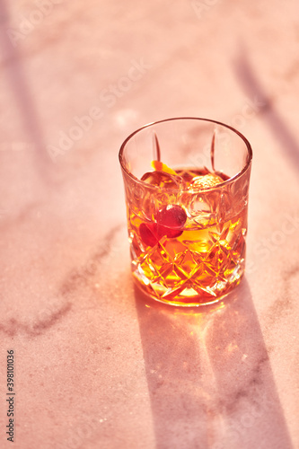 Cocktail Glass with Whiskey or Brown Liquor on Bright Table