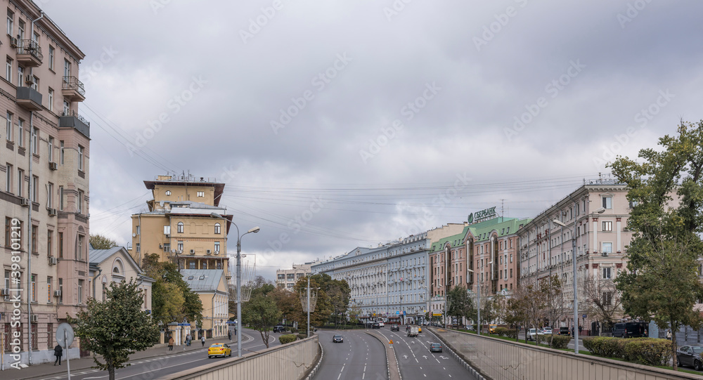  Along the streets moving pedestrians and vehicles