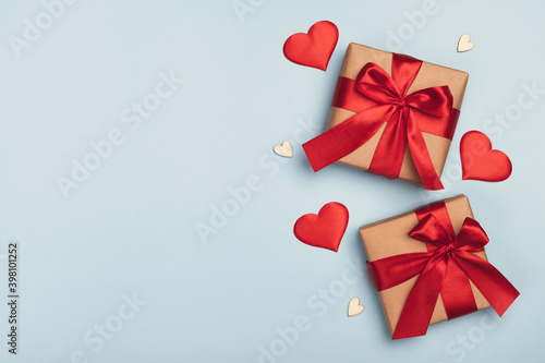 Gift boxes with decorative hearts on light blue background. Valentines day postcard. Top view  flat lay  copy space