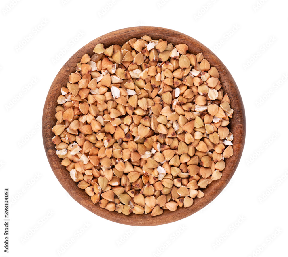 Buckwheat groats in wooden bowl, isolated on white background. Green buckwheat seeds. Top view. Buckwheat groats in wooden bowl, isolated on white background. Green buckwheat seeds. Top view.