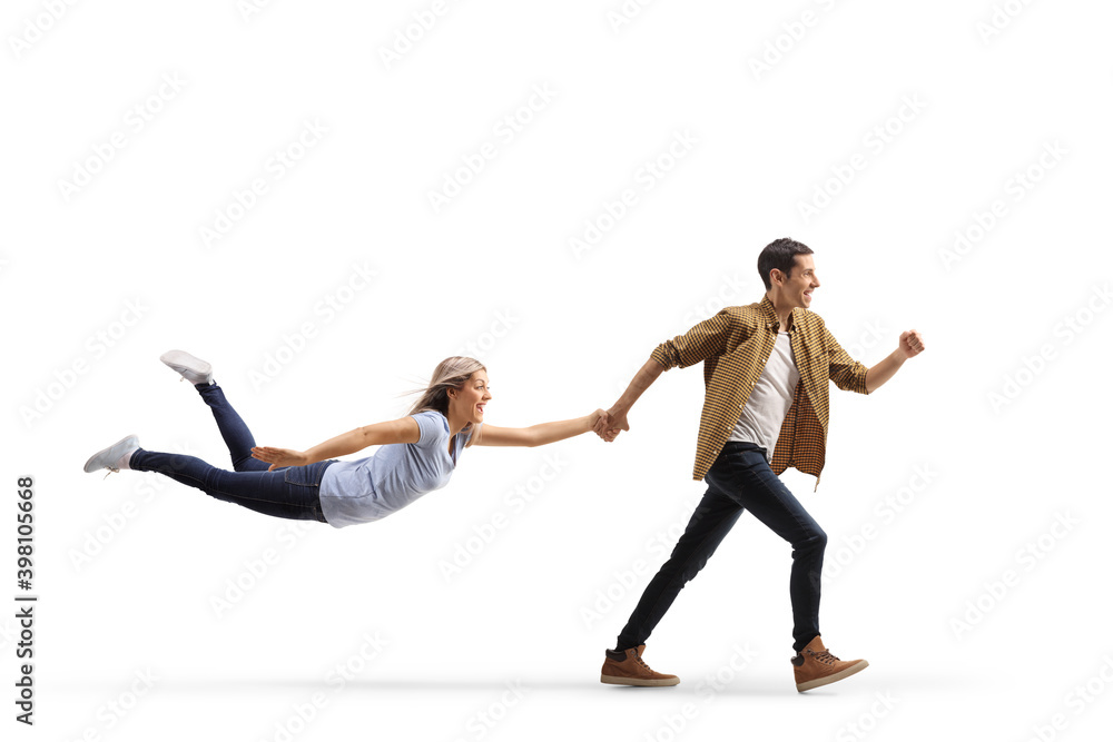 Casual man running and holding a woman with his hand