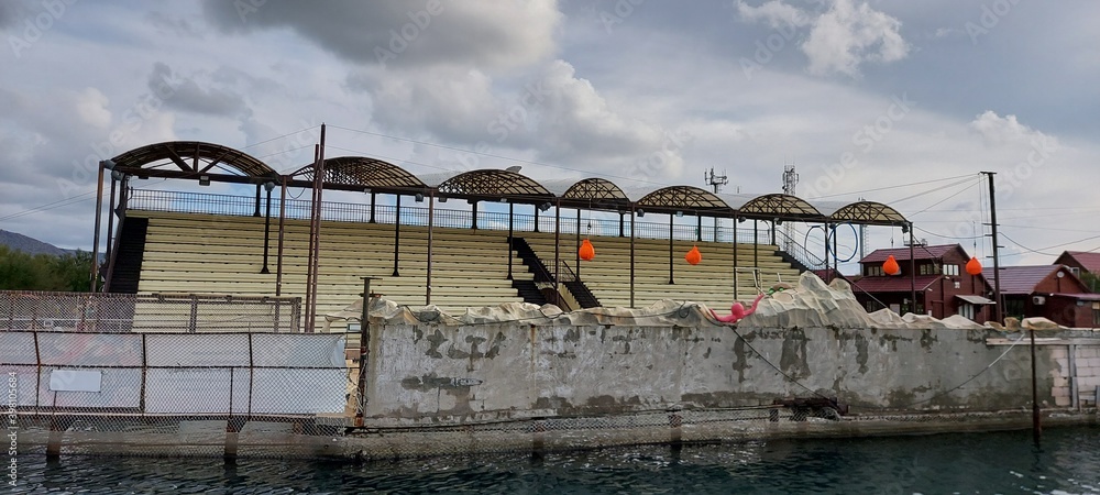 Naklejka premium Empty stands of the Dolphinarium, which was closed for the winter.