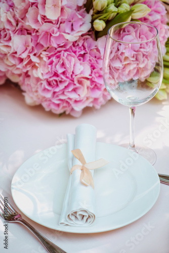 flowers and glass, plate, fork, knife on the table. Cutlery, food, lunch, party concept © k8most