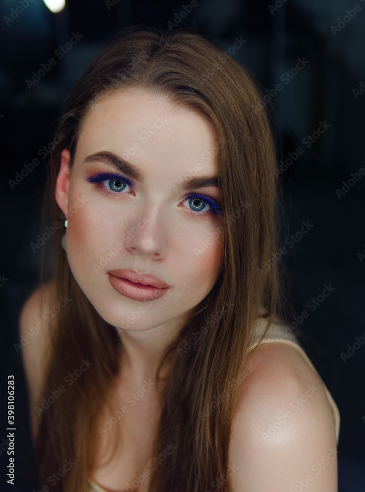 Close up portrait of beautiful woman professional trendy makeup with cobalt blue color eyelashes by artist with ring light reflection in model eyes Close up portrait of beautiful woman professional trendy makeup with cobalt blue color eyelashes by artist with ring light reflection in model eyes