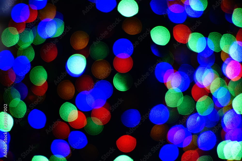 Christmas and new year tree decorated and lighted at night closeup abstract