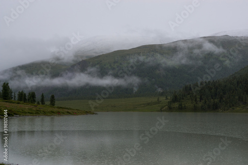 high mountain lake Akkem with mountains shrouded in clouds