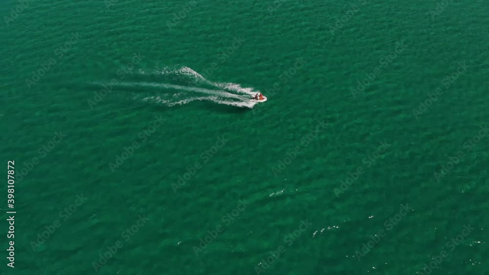 Aerial view of a small speed boat in the bay. Light water transport top view. Amazing view of the tropical bay of turquoise water Aerial view of a small speed boat in the bay. Light water transport top view. Amazing view of the tropical bay of turquoise water