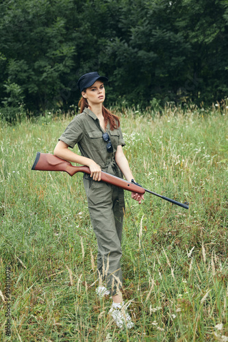 Military woman Weapon in hand hunting lifestyle green leaves