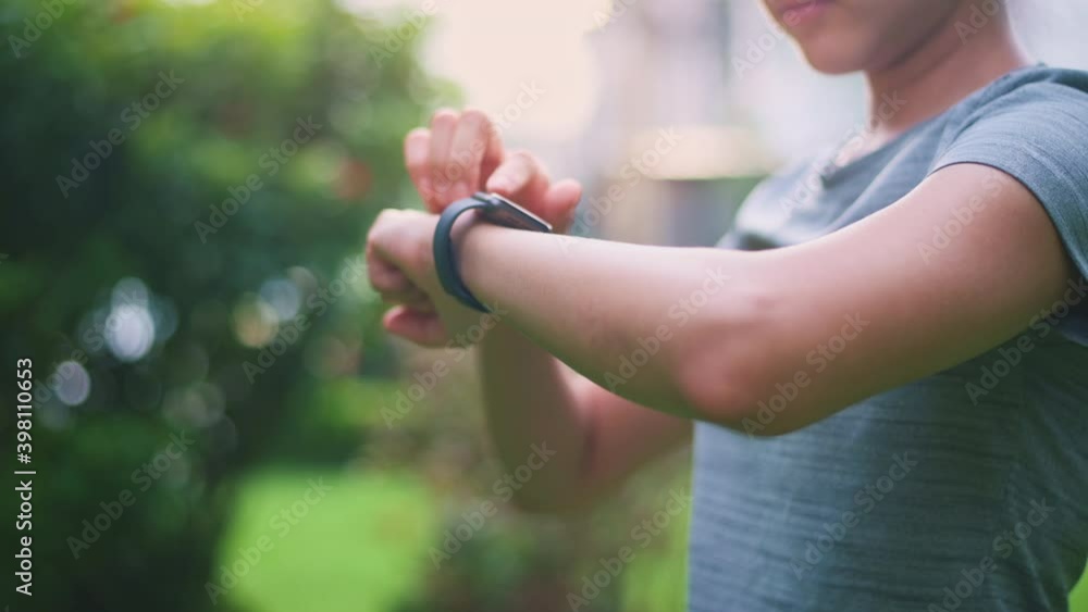 Close up fitness woman hands is touching her smart watch fitness technology concept. Close up fitness woman hands is touching her smart watch fitness technology concept.