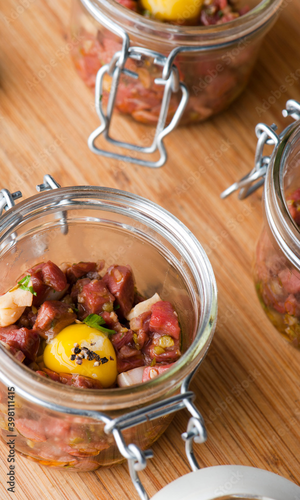 Steak tartare. Classic American restaurant or French bistro appetizer classic. Steak diced, mixed with eggs, red onions, olive oil, lemon juice, garlic and capers. Served with garlic bread. Steak tartare. Classic American restaurant or French bistro appetizer classic. Steak diced, mixed with eggs, red onions, olive oil, lemon juice, garlic and capers. Served with garlic bread.